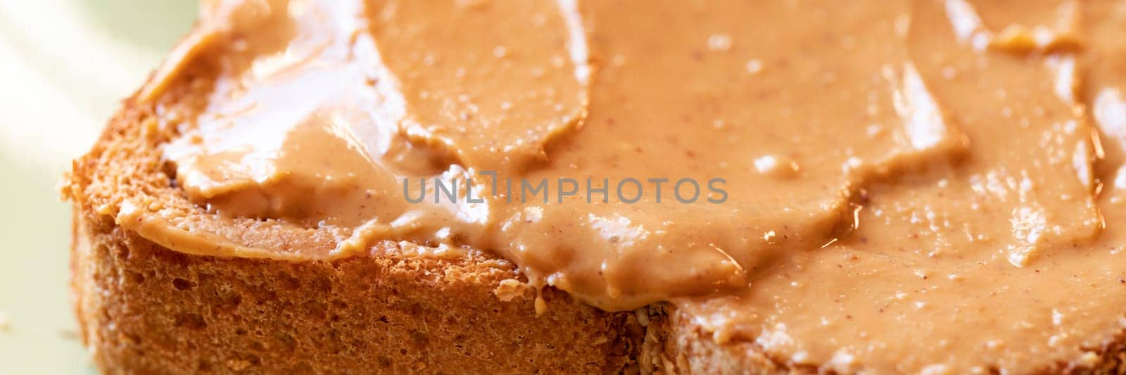 Creamy peanut butter spread on healthy whole wheat toast bread