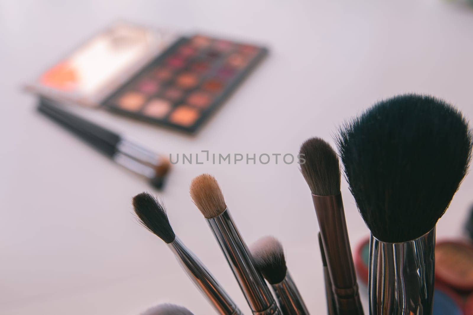 Makeup cosmetics tools background & beauty cosmetics, products & facial cosmetics package lipstick, eyeliner, concealer, mascara, eye shadow stick & highlighter palette on white color background.