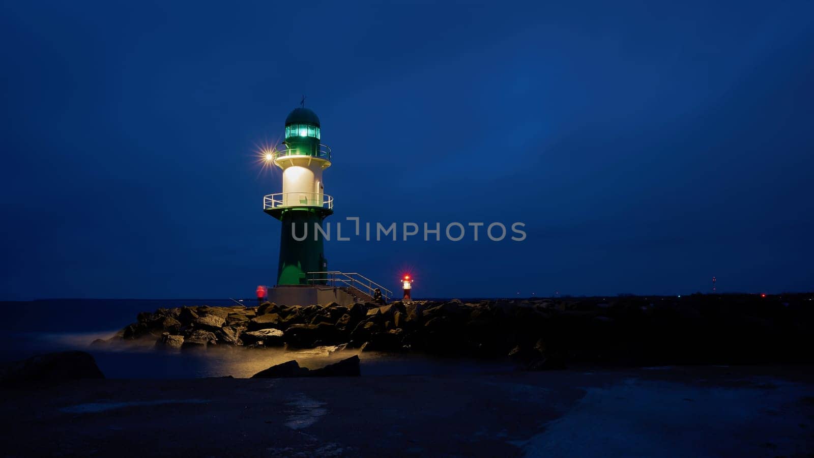 The lighthouse Molenfeuer on the western pier at the coast of Warnemuende in Germany