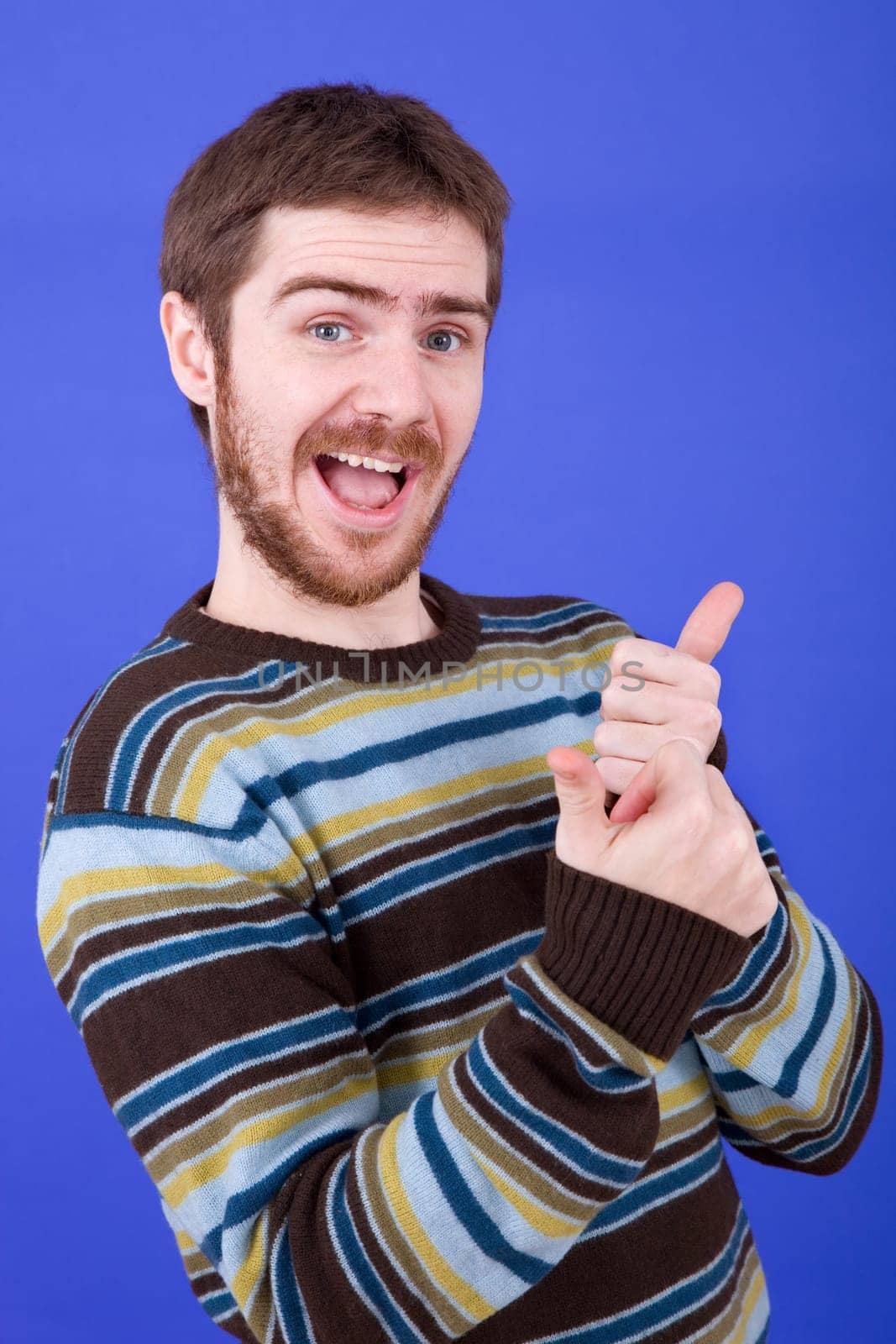 an young man portrait over a blue background