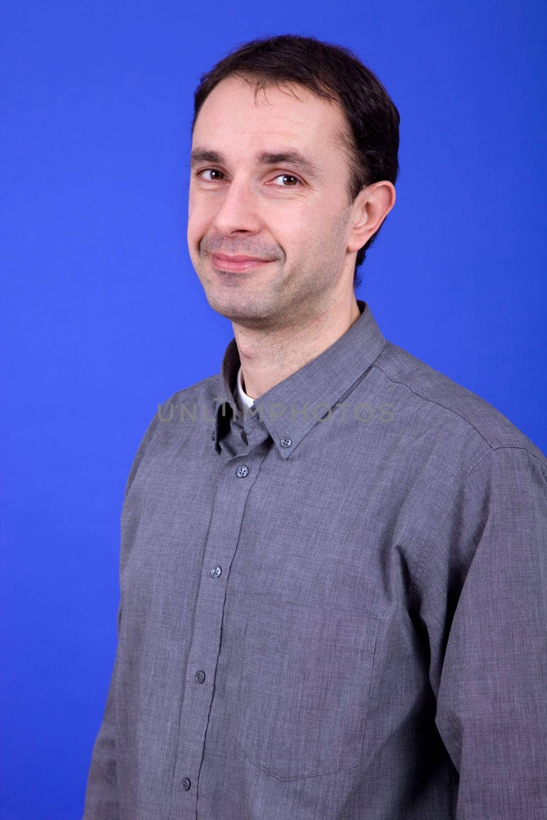 an young man portrait over a blue background