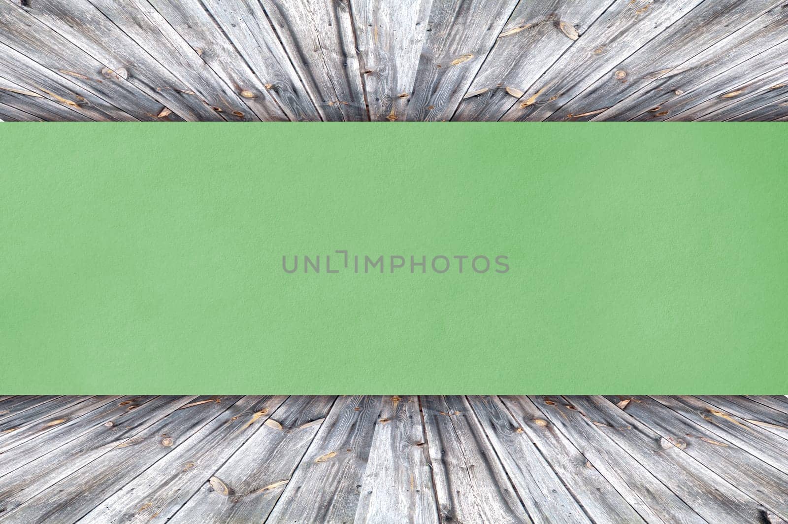 green paper on wood background or texture