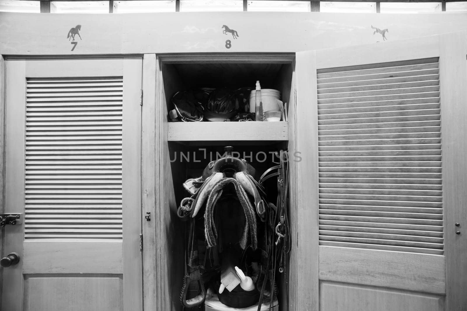 A rider keeps gear close to her horse in this tack closet