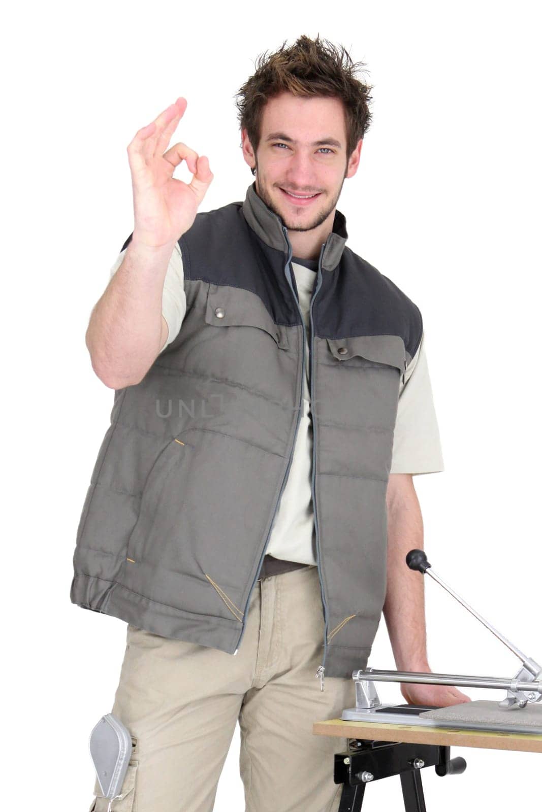 portrait of young tiler making okay sign