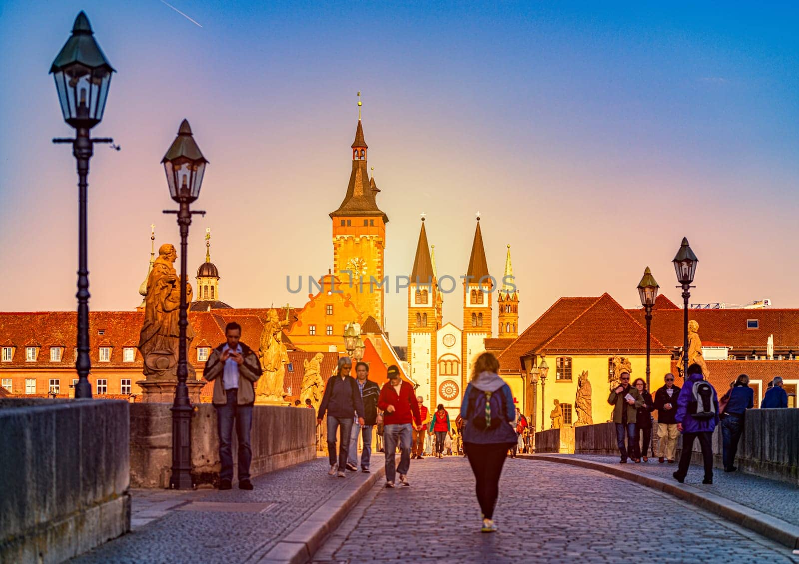 Wurzburg, Germany - September 23, 2014: Old bridge and church with people walking in Wurzburg, Bavaria, Germany