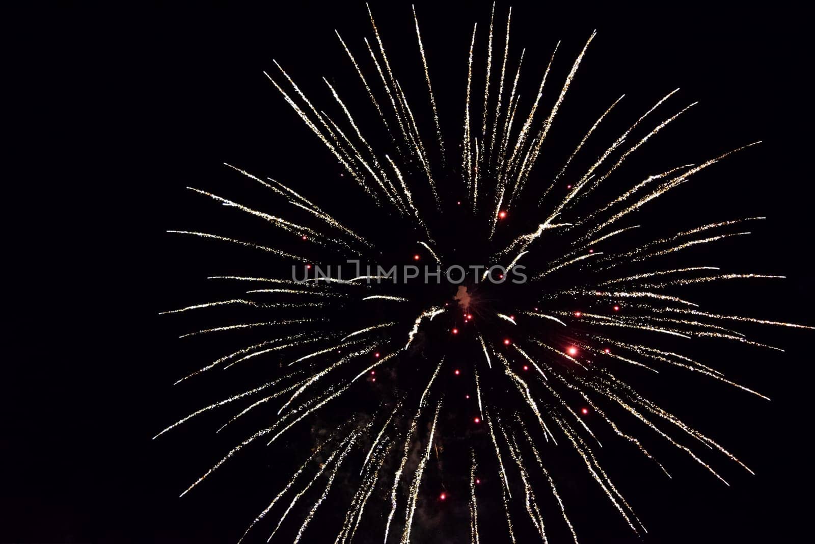 Festive salute in the night sky. Explosions of fireworks and pyrotechnics in the sky.
