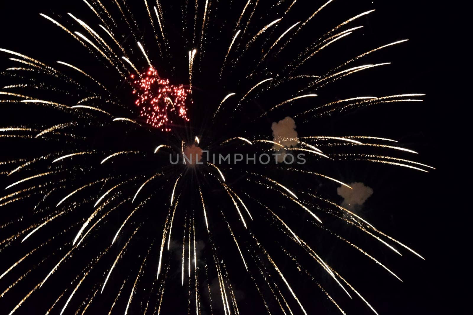 Festive salute in the night sky. Explosions of fireworks and pyrotechnics in the sky.