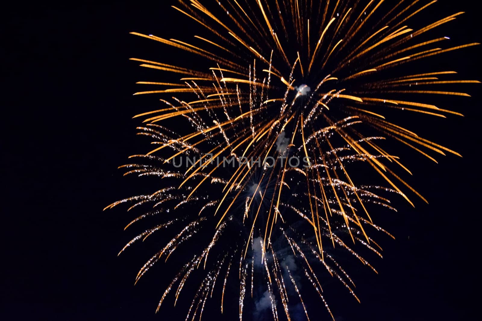 Festive salute in the night sky. Explosions of fireworks and pyrotechnics in the sky.