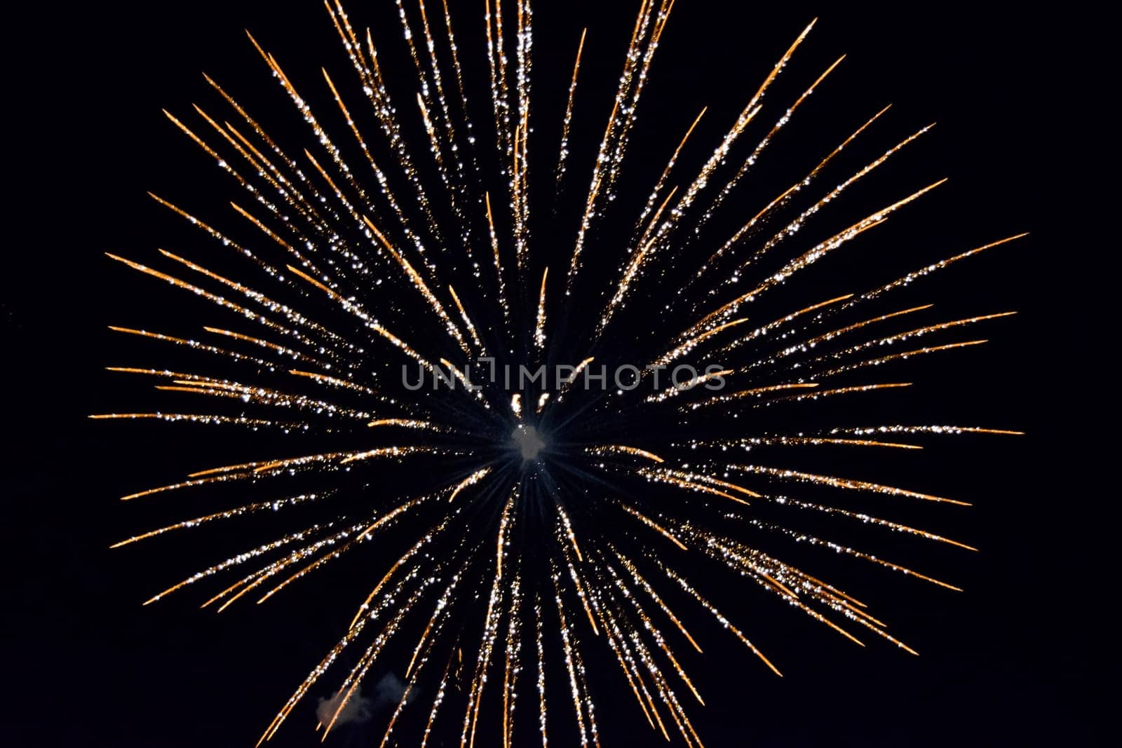 Festive salute in the night sky. Explosions of fireworks and pyrotechnics in the sky.