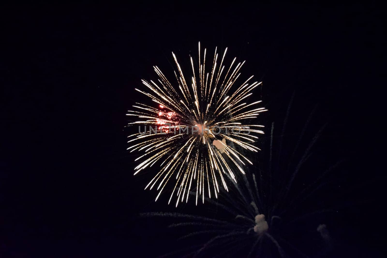 Festive salute in the night sky. Explosions of fireworks and pyrotechnics in the sky.