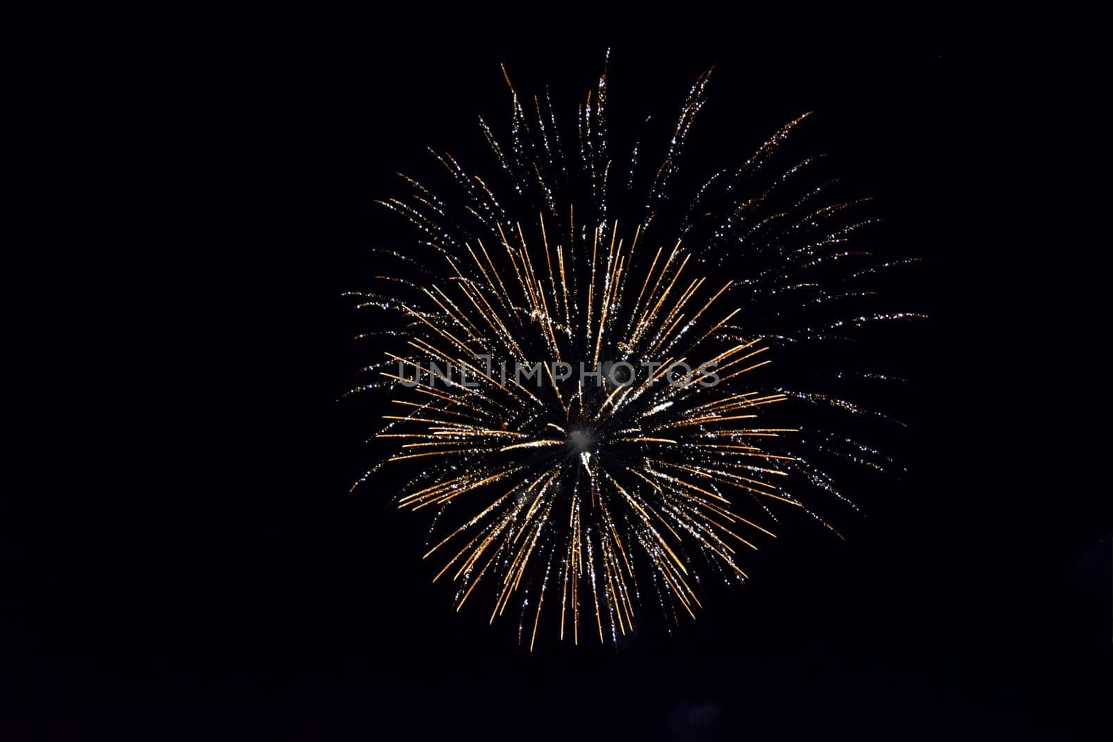 Festive salute in the night sky. Explosions of fireworks and pyrotechnics in the sky.