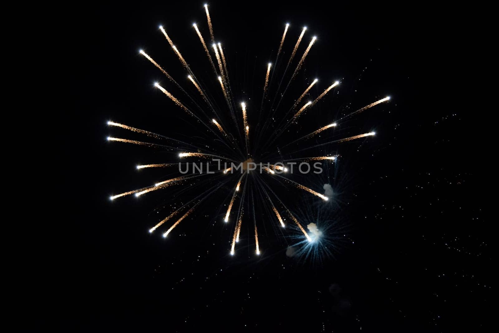 Festive salute in the night sky. Explosions of fireworks and pyrotechnics in the sky.
