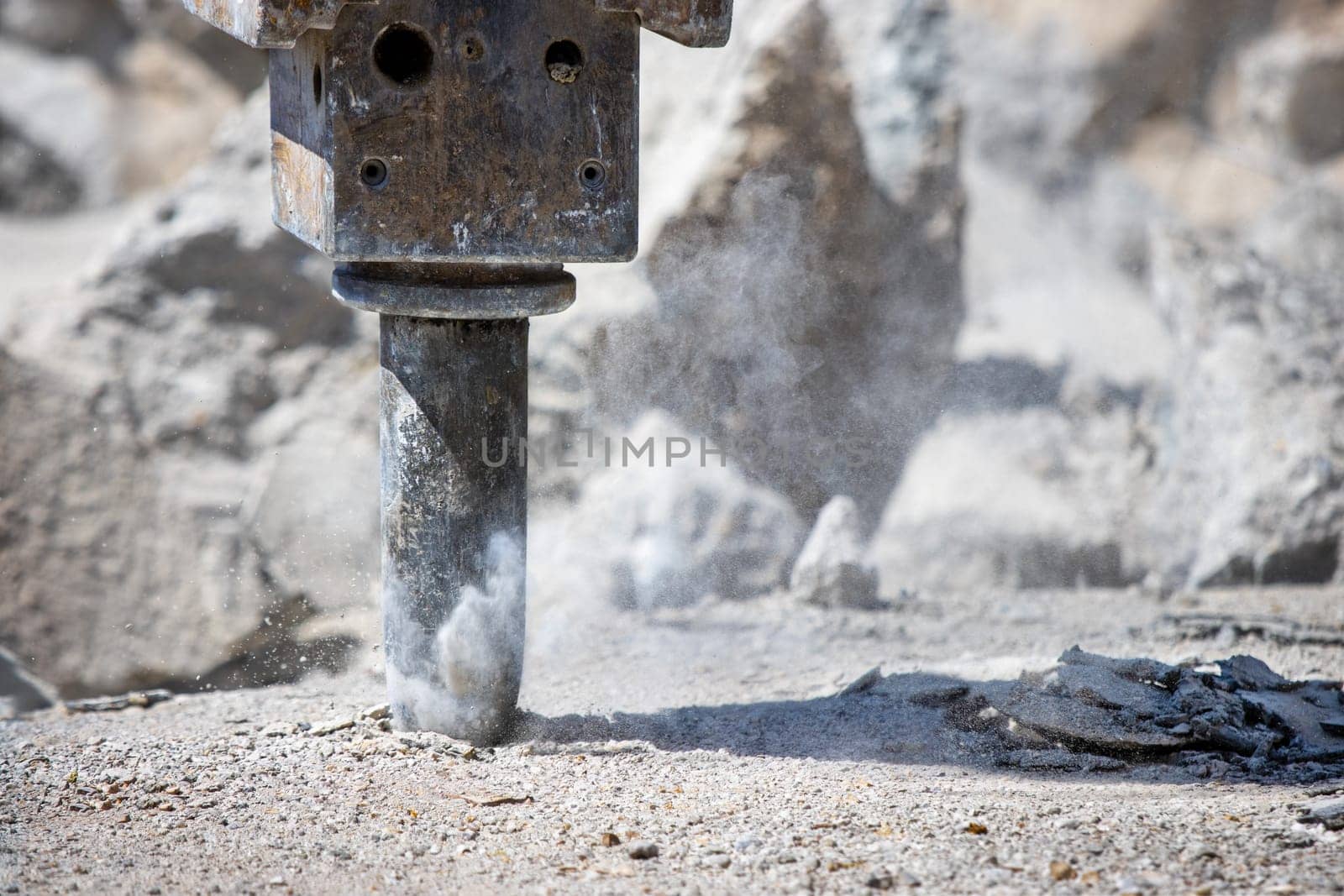Jackhammer and concrete drilling, hammering for hole and making dust on constrction site. Spiritual force and penetration concept.