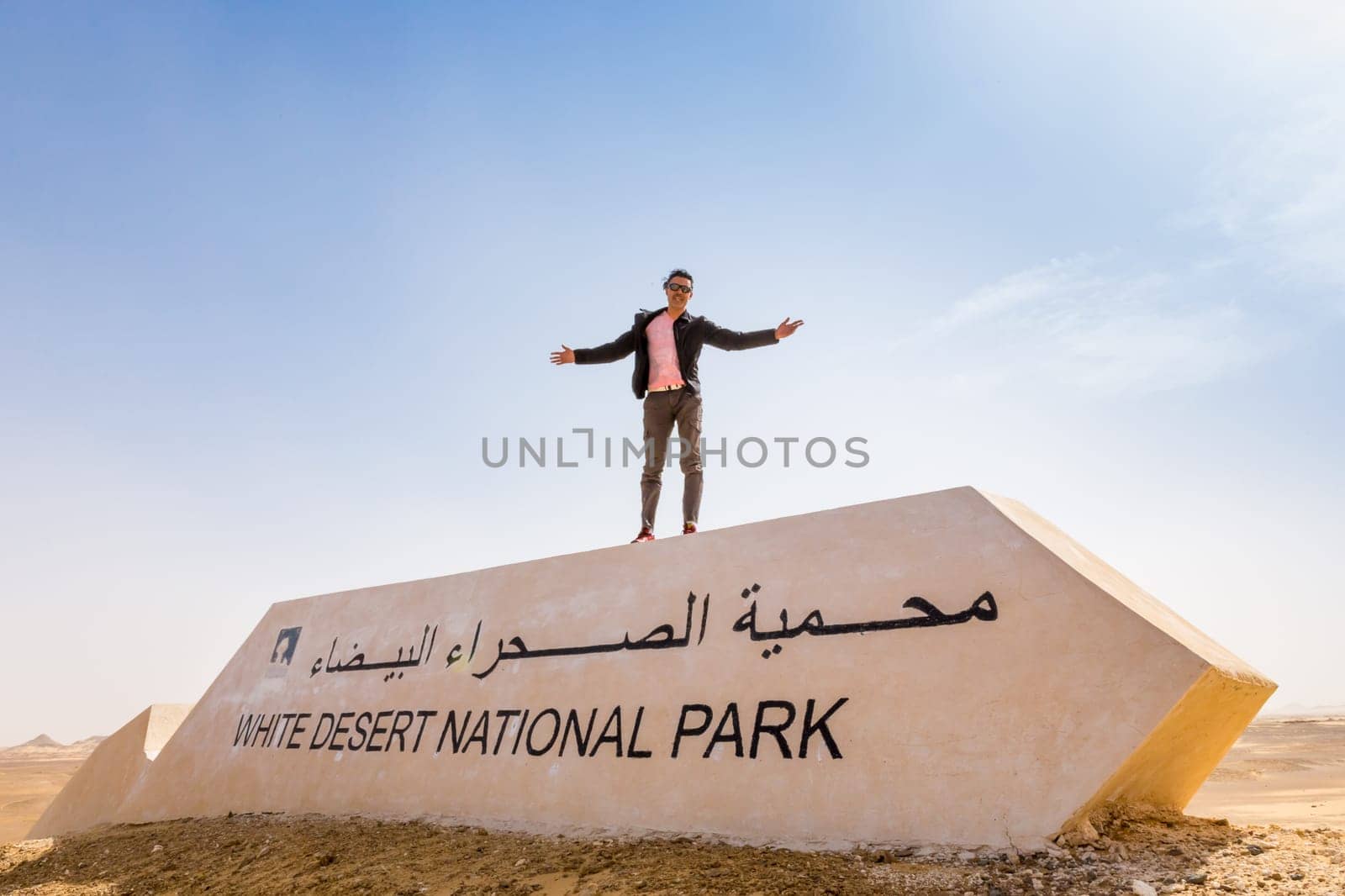 Man with open arms in the White Desert, Egypt.