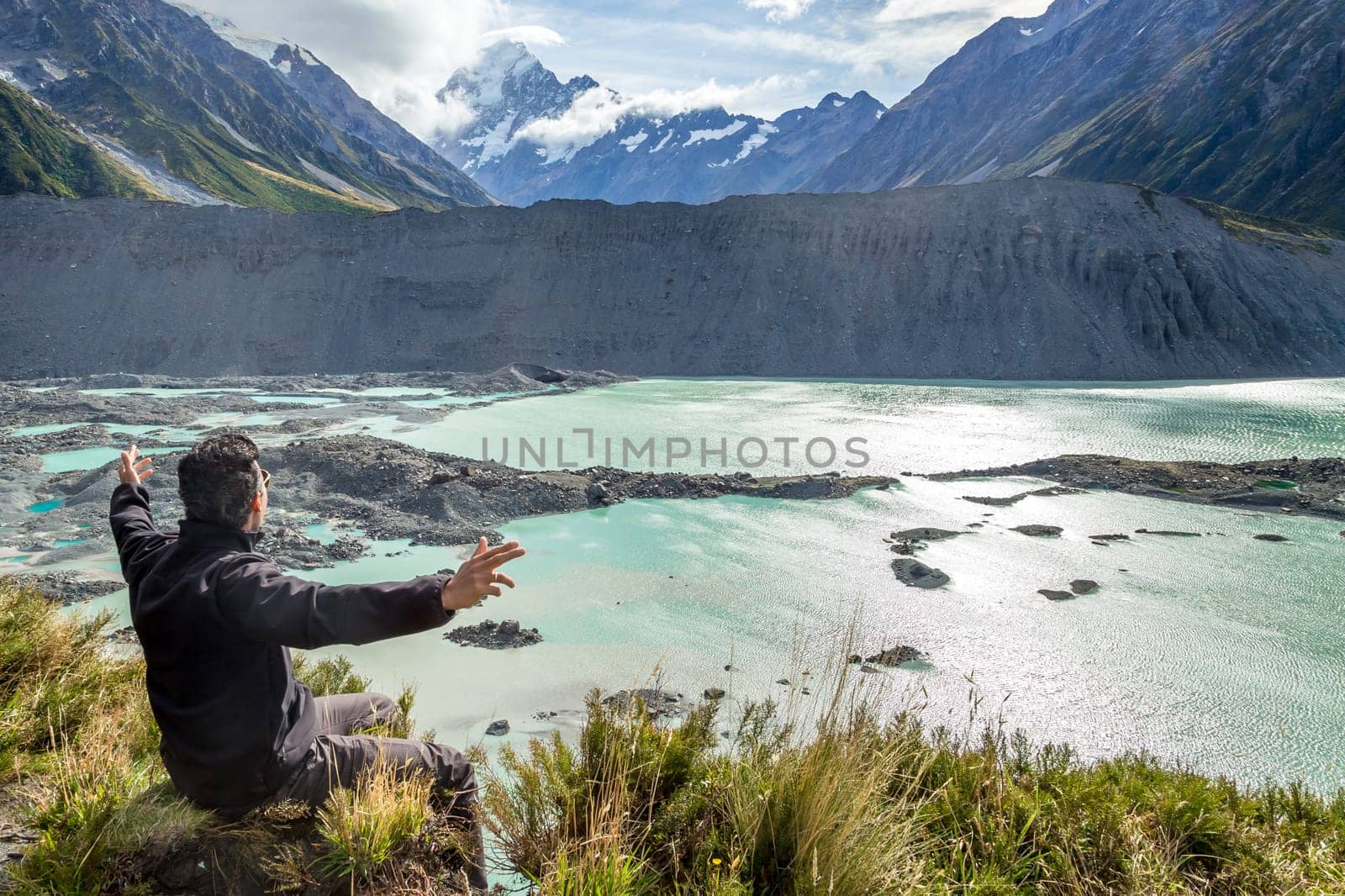 Man with open arms during at Mount Cook, New Zealand ..