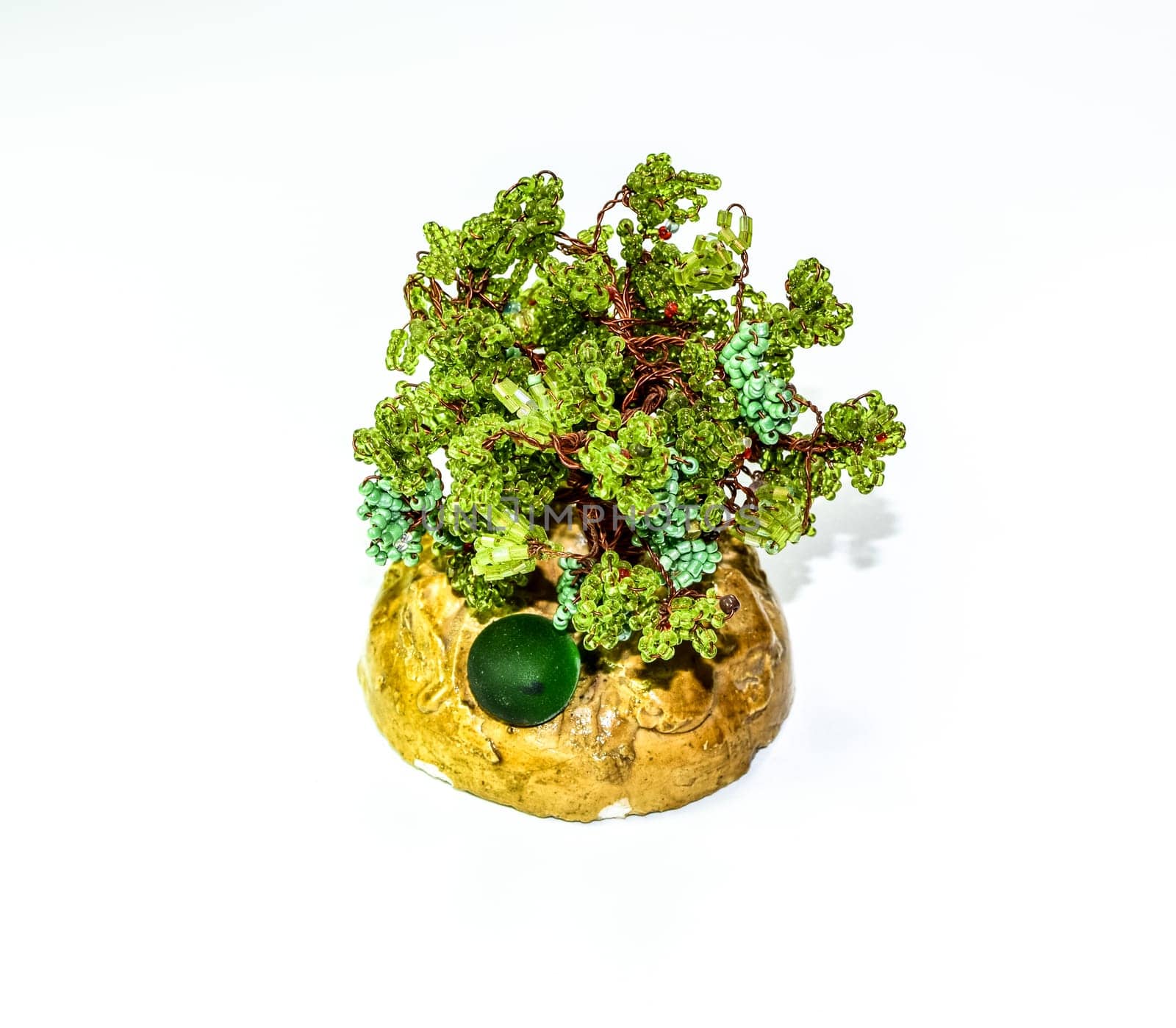 Creative wood made of copper wire and green beads.