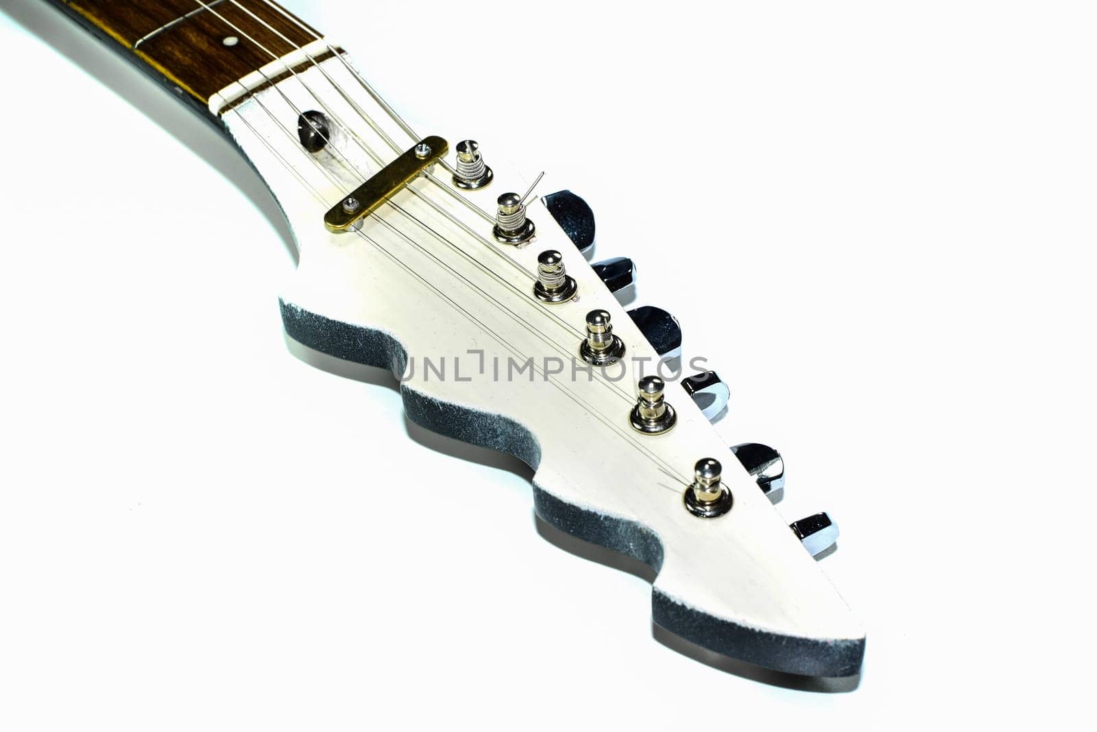The griffin of the electric guitar on a white background. Musical instrument