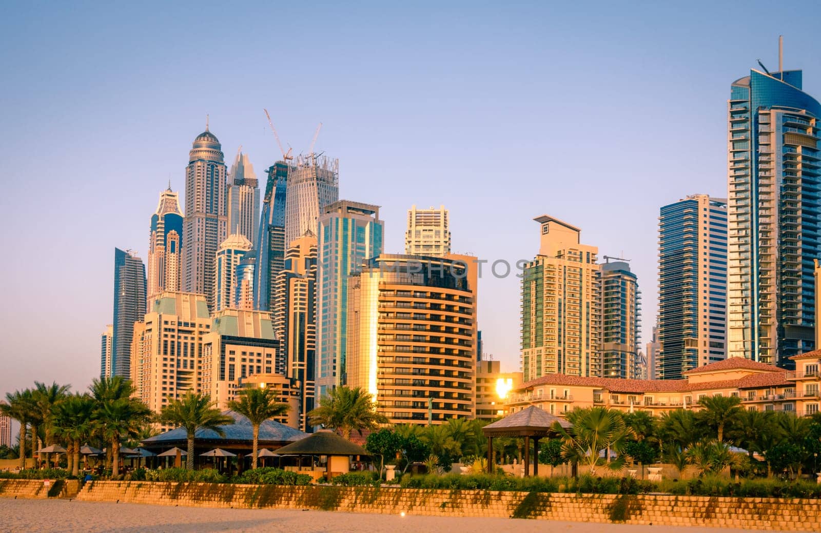 View of Dubai Marina skyscrapers from the seaside at sunset. Dubai, UAE