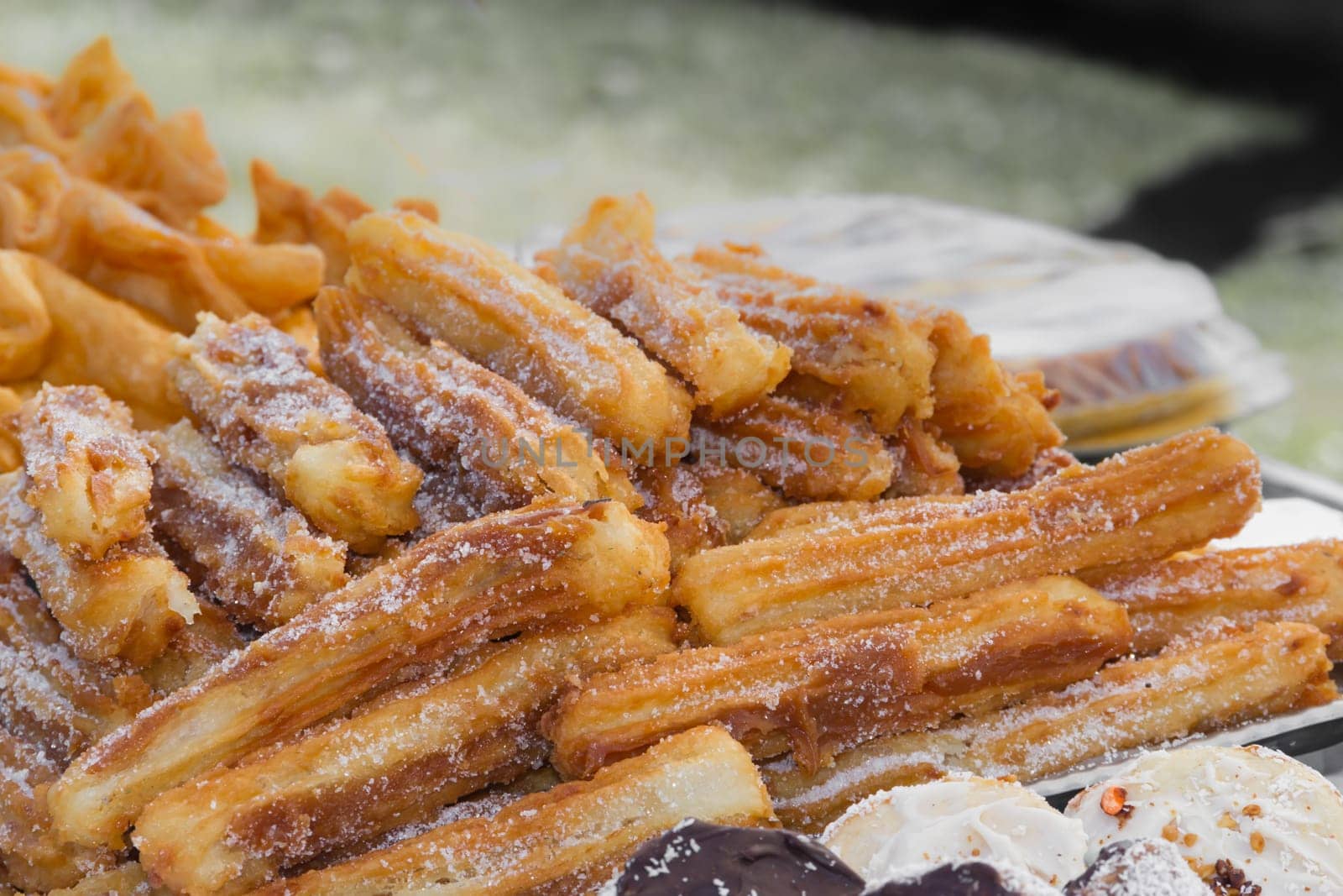 sweet churros and alfajores for sale at the street fair