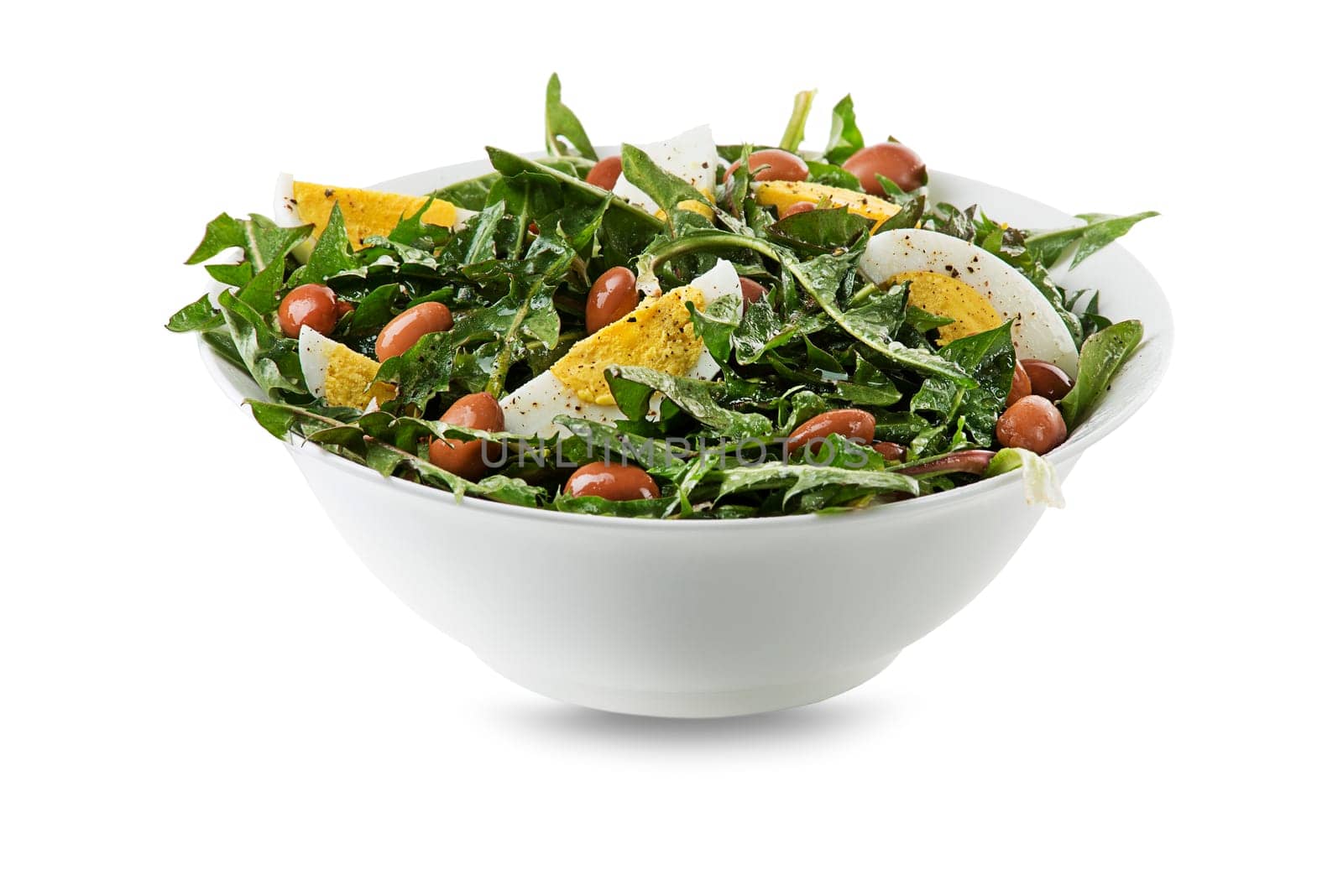 Healthy Green salad with dandelion leaves, egg and beans isolated on white