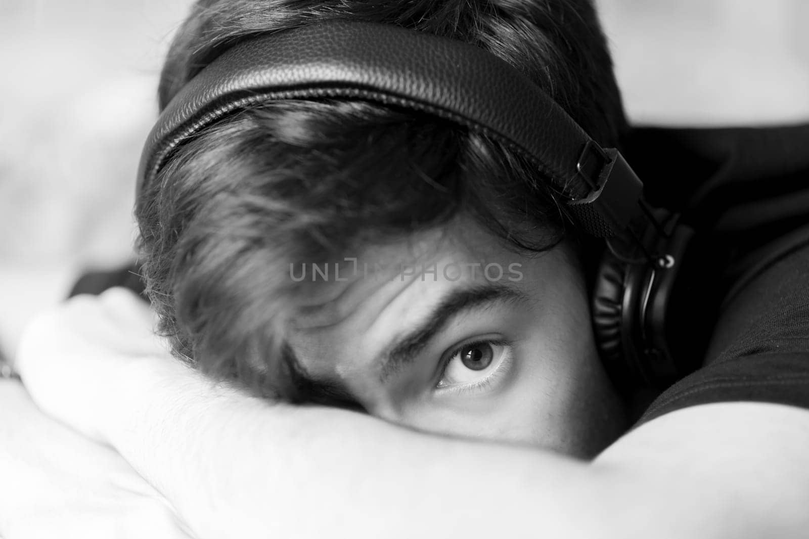 Portrait of young teenage boy with headphones. Black and white photography.