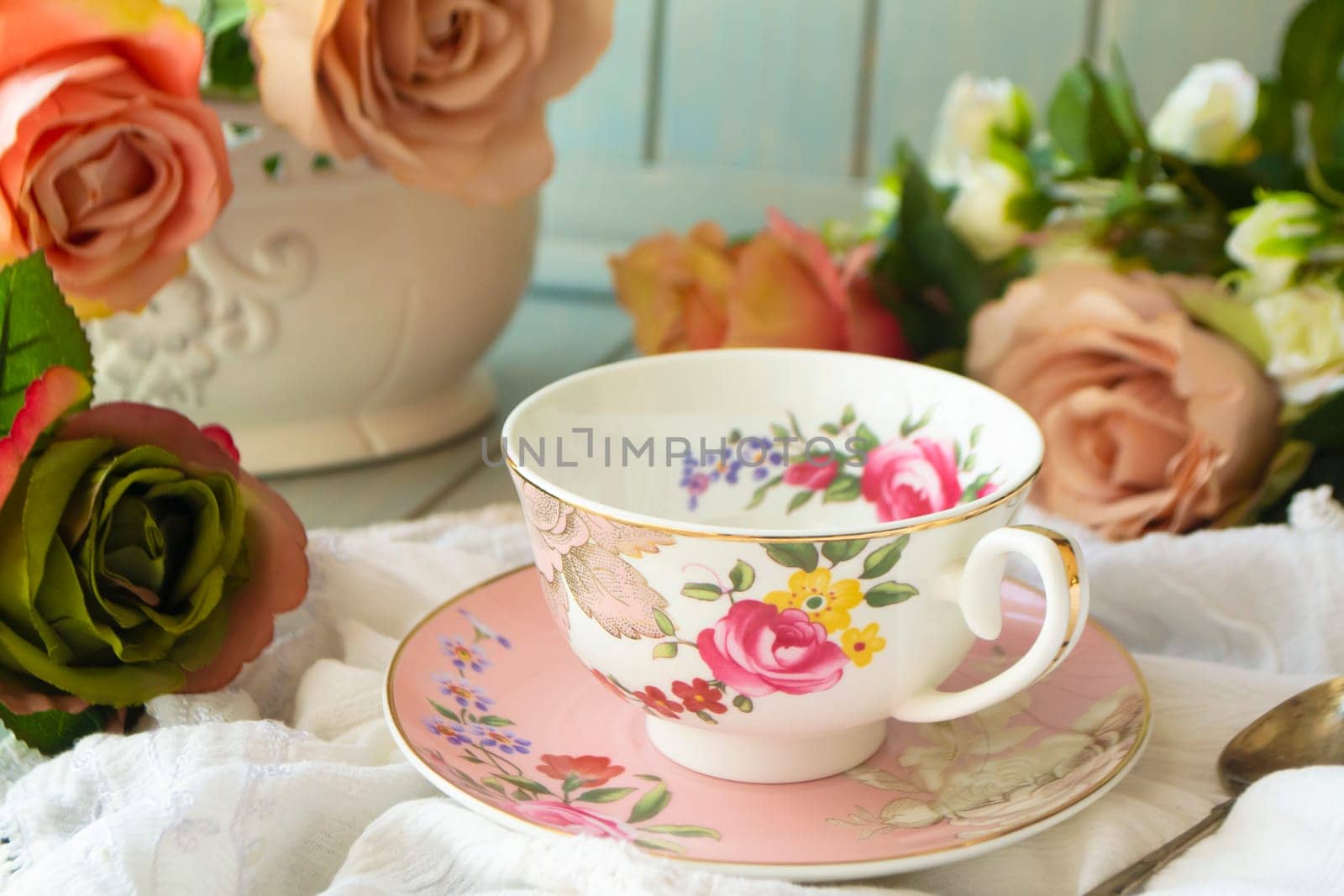 Vintage tea cup, frame of pastel roses flowers