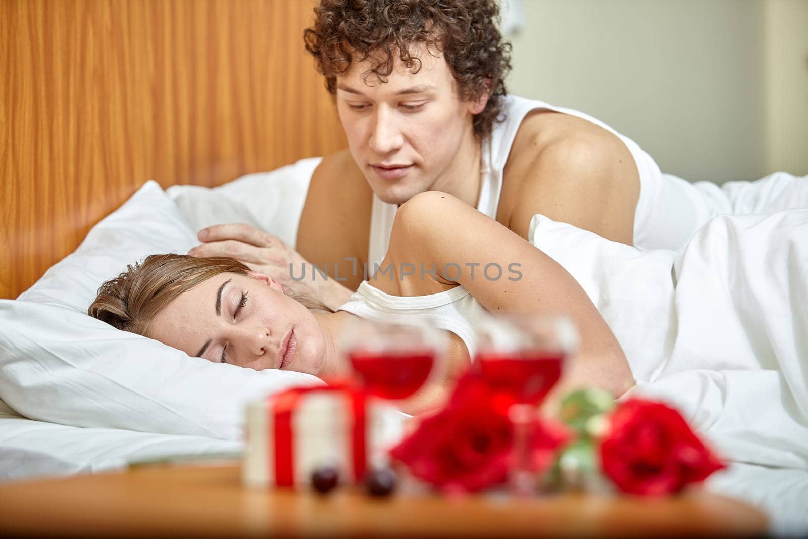 Happy young family sleep in the bed at home. Valentine's Day.