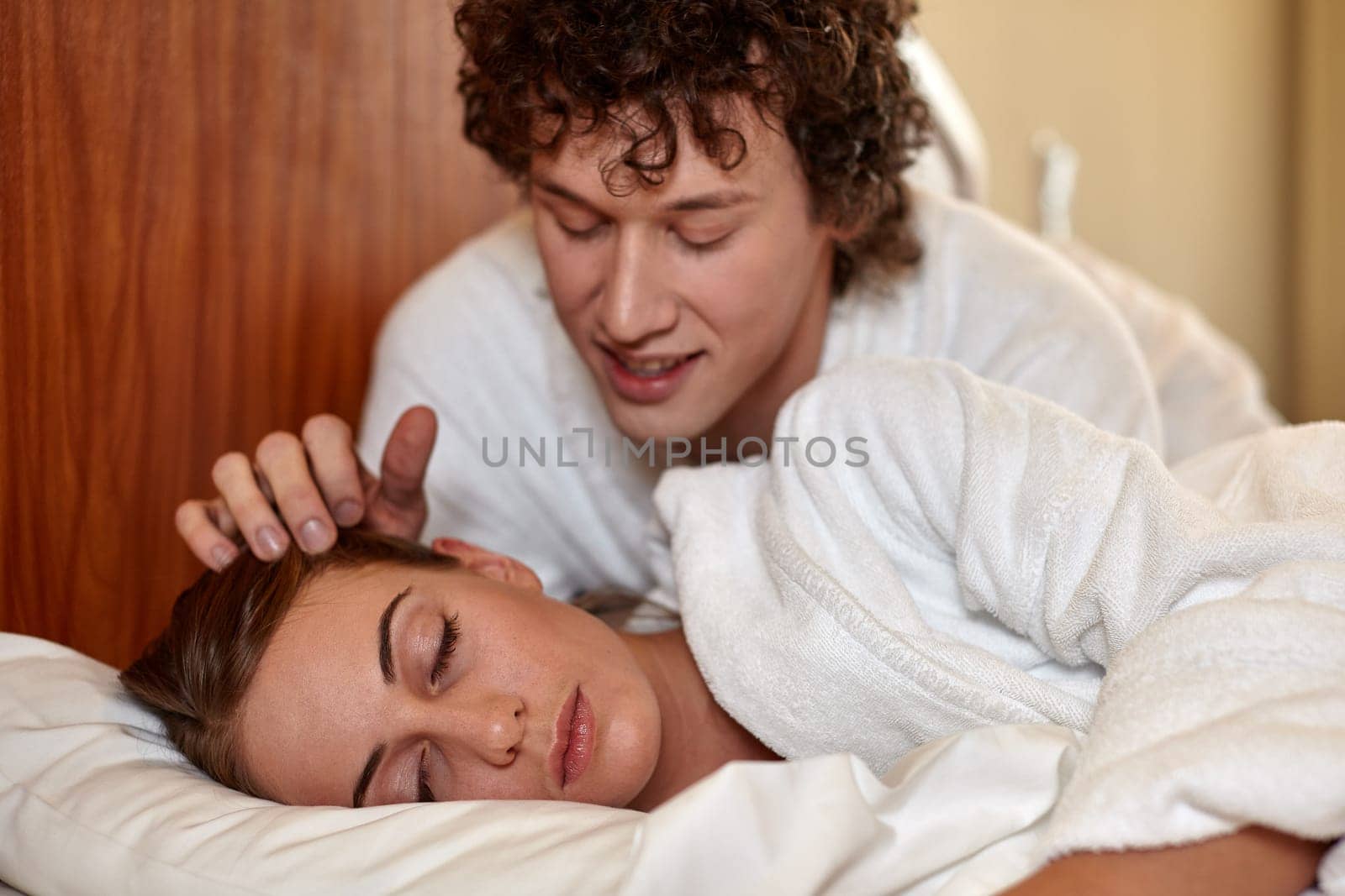 Happy young family  lies in the bed at home.