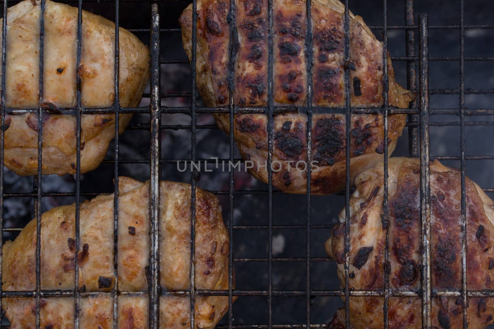 Delicious meat, grilled on a grill with a delicious crust cooked in the open air