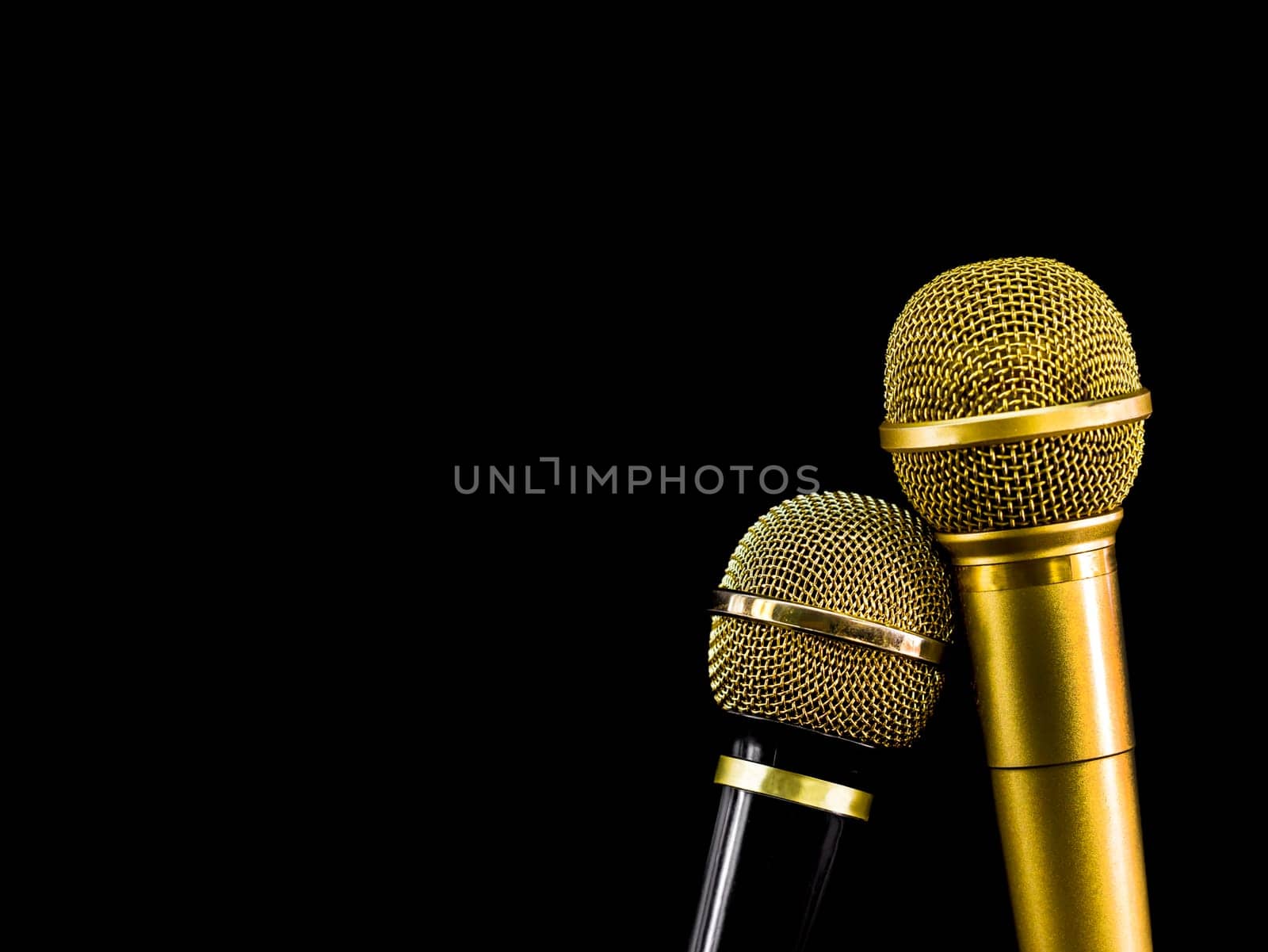 Two microphone on black background.  Object for entertainment concept.