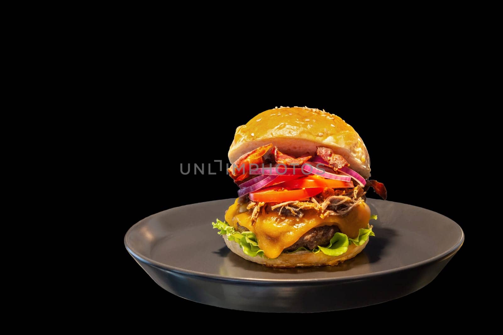 Close-up of home made burgers with fire flames and black background