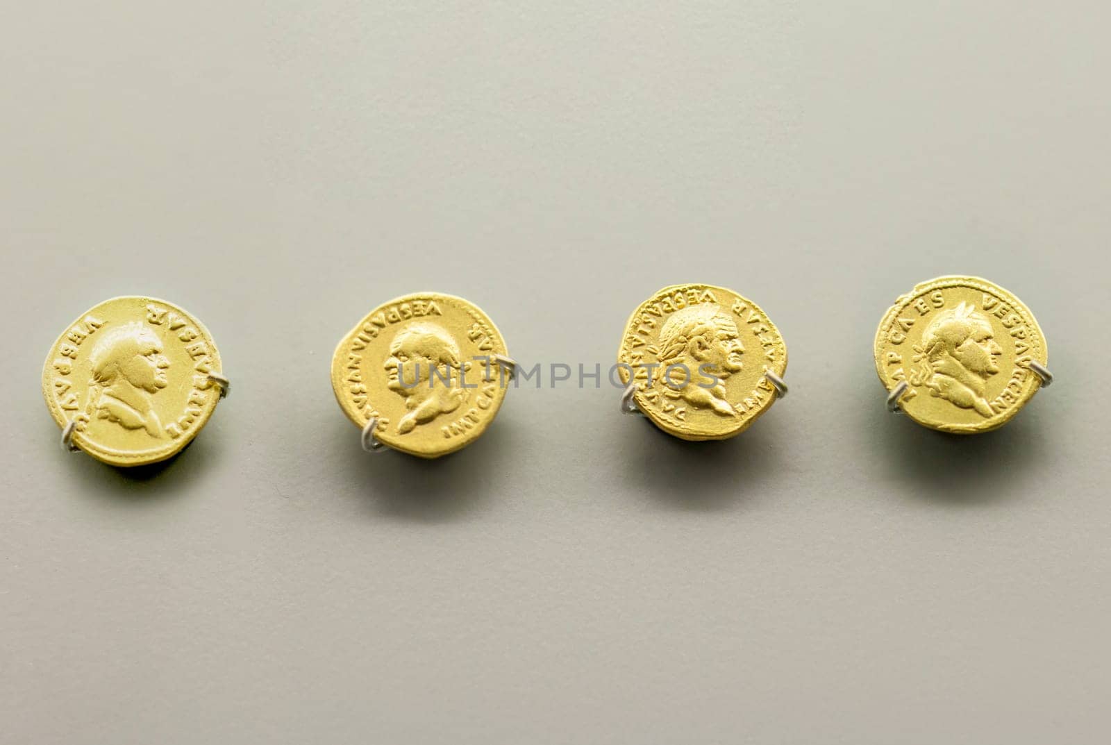 Merida, Spain - August 25th, 2018: Gold Roman Imperial coins bearing the bust of Emperor Vespasian. National Museum of Roman Art in Merida, Spain