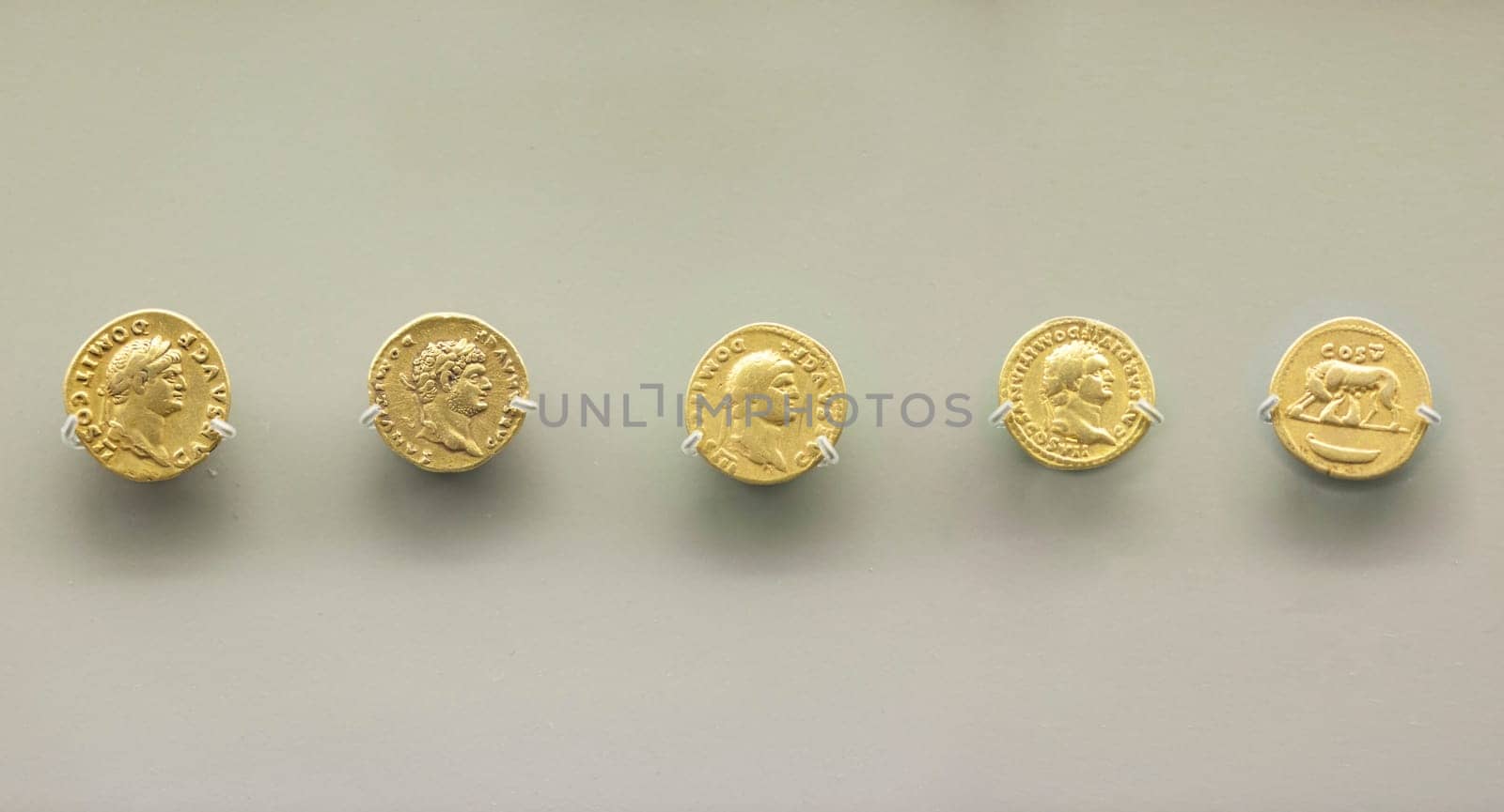 Merida, Spain - August 25th, 2018: Domitian Roman emperor gold coins. National Museum of Roman Art in Merida, Spain. Selective focus