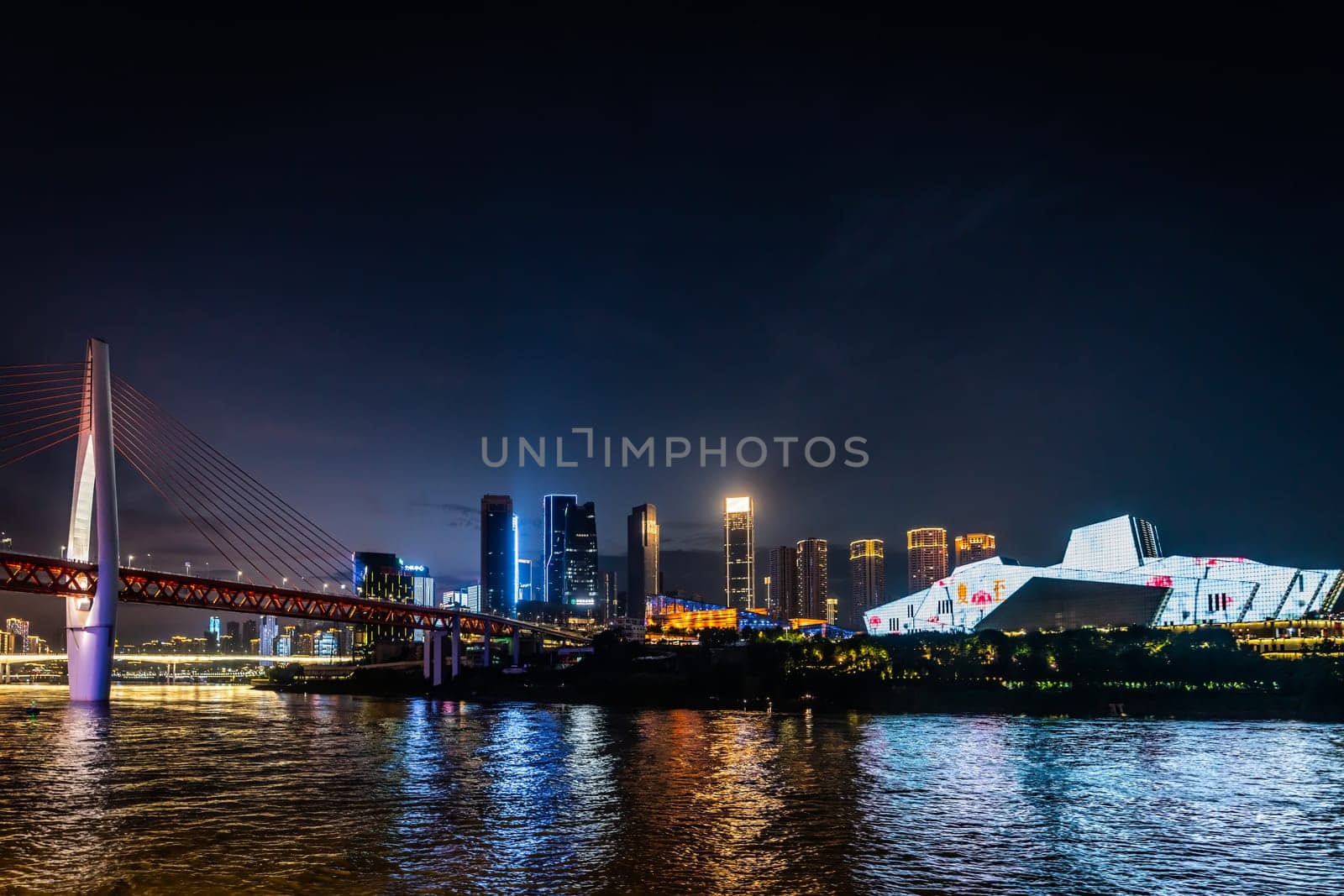 Chongqing, China -  August 2019 : Illuminated DongShuiMen road bridge over and across mighty Yangtze river in Chongqing town at dusk