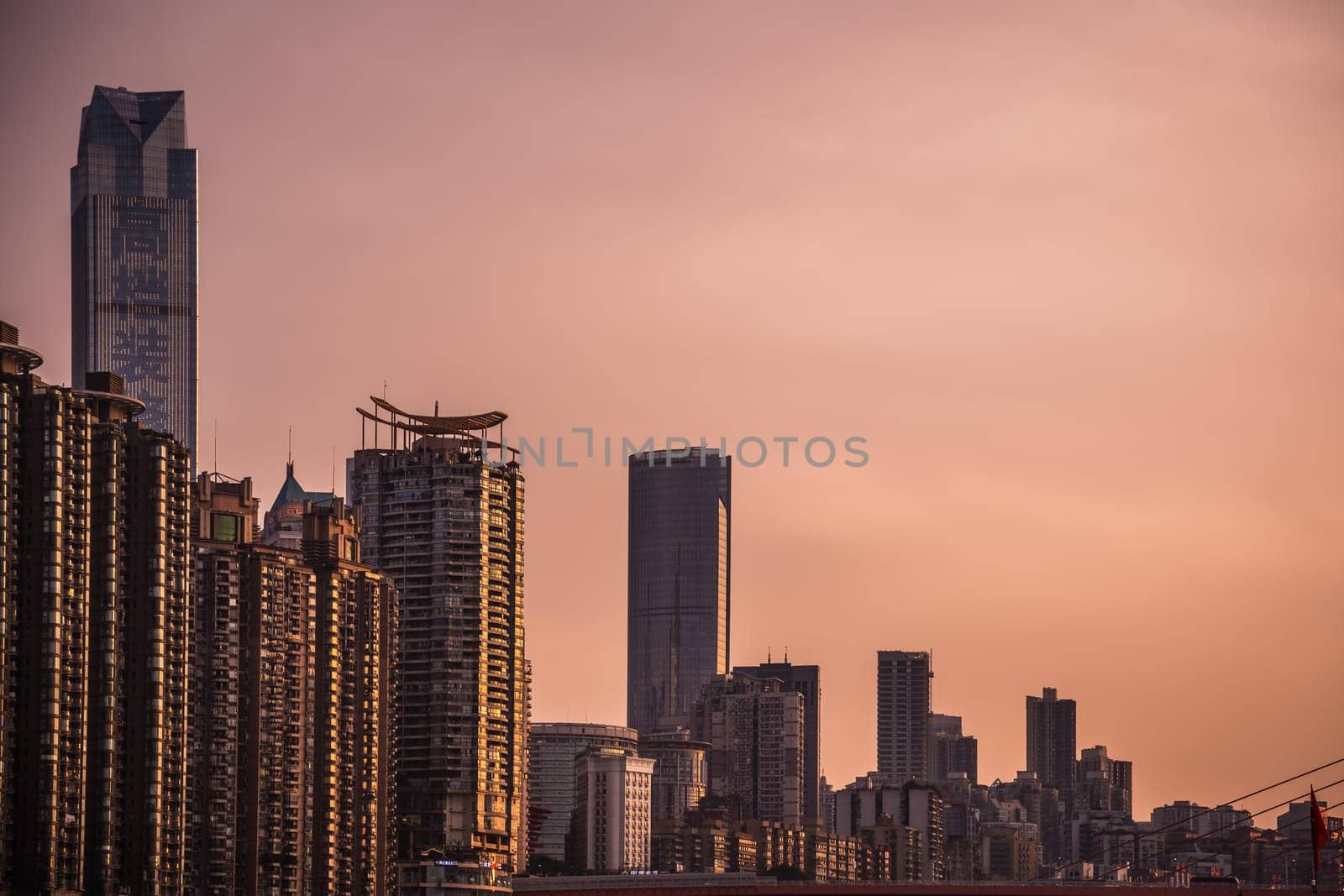 Chongqing, China -  August 2019 : View of the tall highrise residential and commercial buildings in the  Chongqing city at dusk