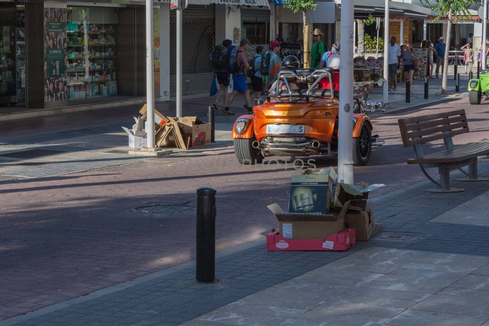 Paguera, MALLORCA, SPAIN - MAY 31, 2016:.Paguera, Mallorca, Spain - May 31, 2016: .. A couple is driving with a rental trike over the shopping street at Paguera Bay.