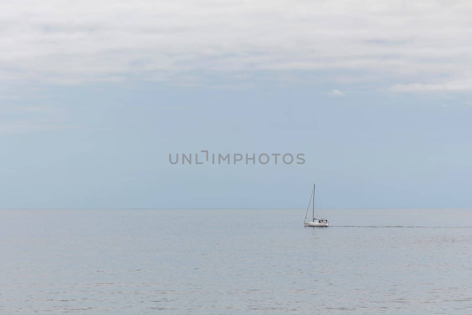 A white boat sailing through a calm sea in the Atlantic ocean