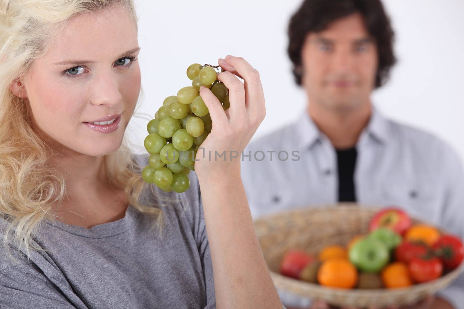 Woman with bunch of grapes