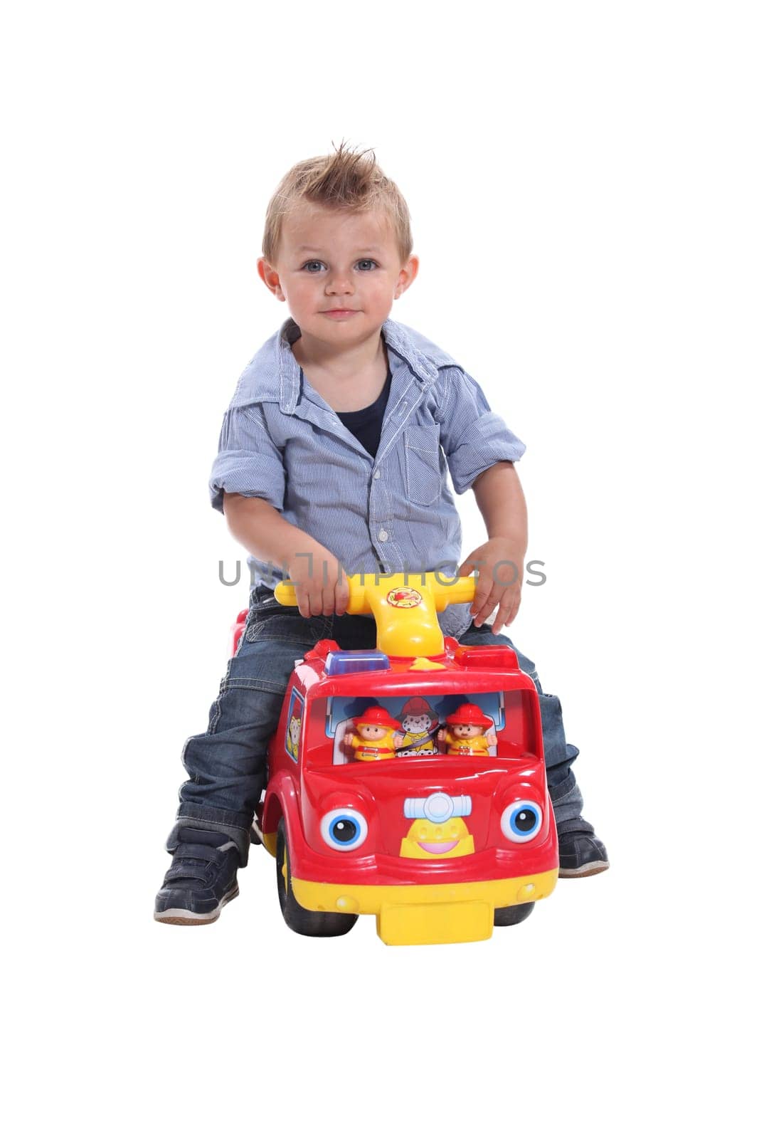 Little boy playing on toy car