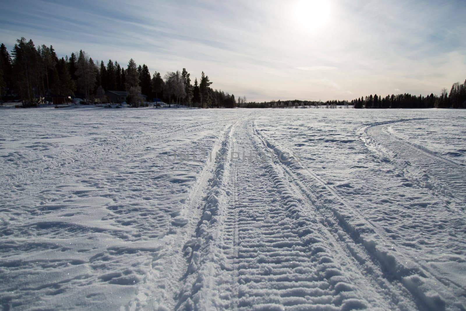 Snowmobile Tracks on Frozen Lake