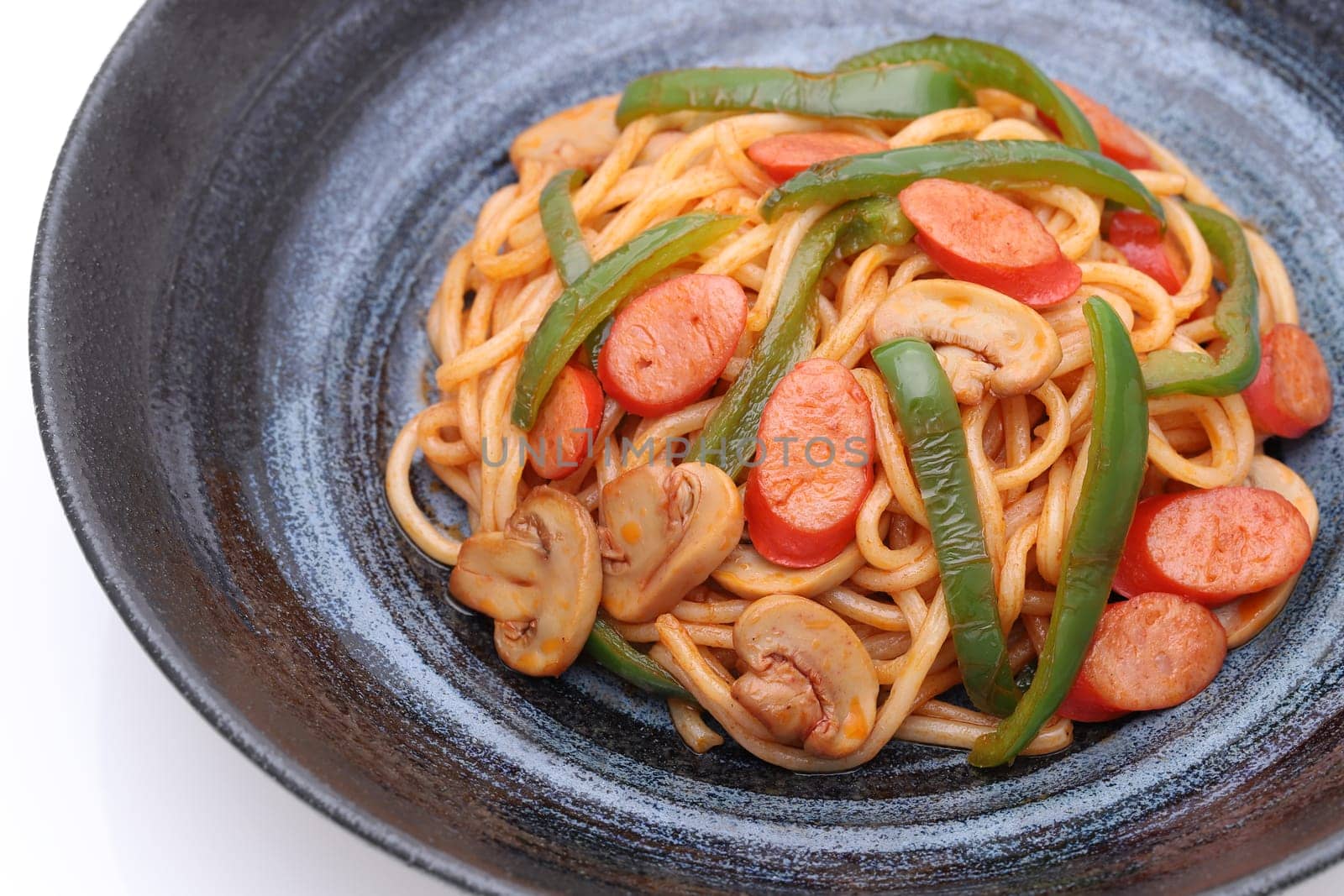 Japanese Naporitan spaghetti with tomato sauce in a dish on white background