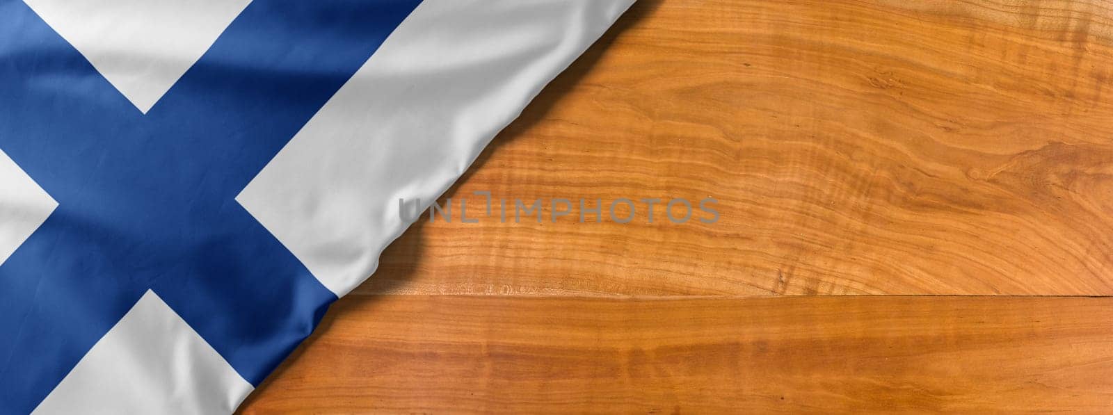 National flag of Finland on a wooden background with copy space