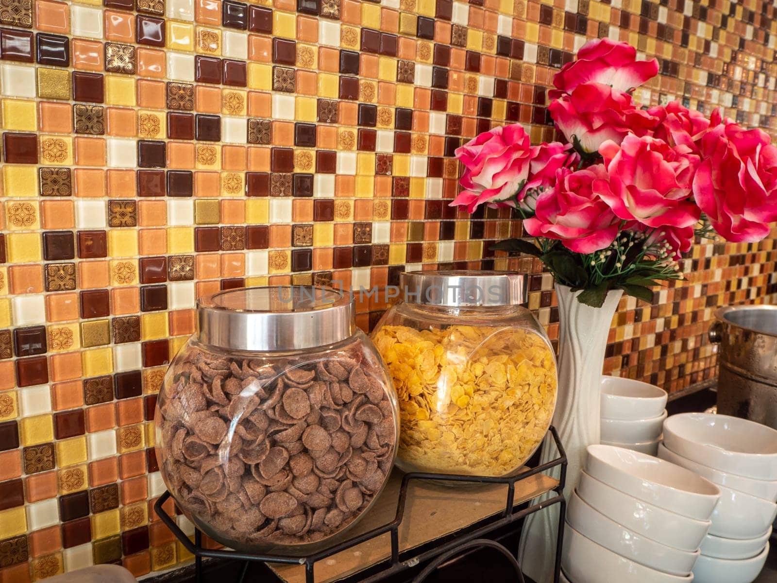 Fruit juice dispensers and coffee & tea water on a self service breakfast counter in a hotel.