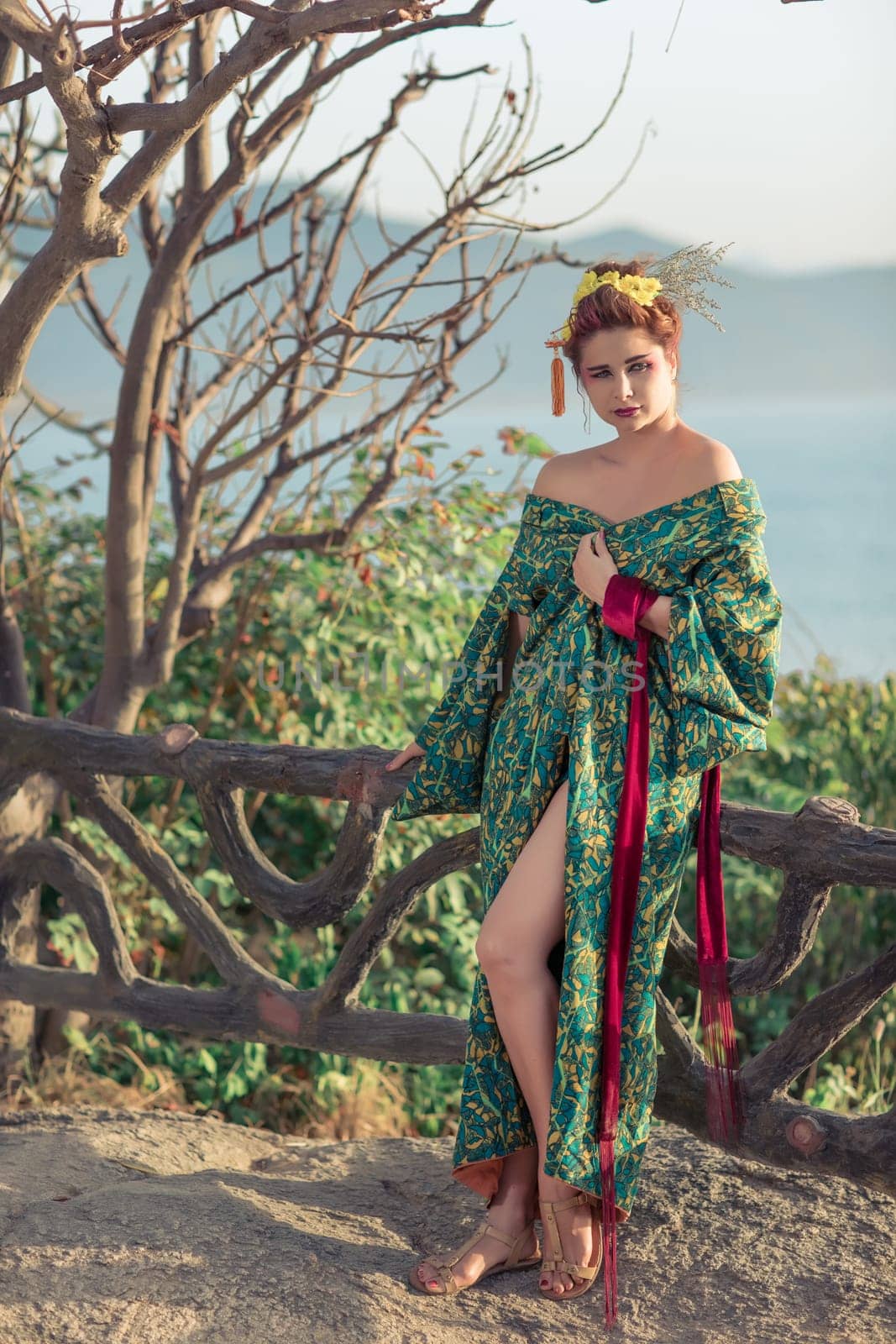 Portrait of a Japanese Geisha in kimono  at sunrise time near the sea