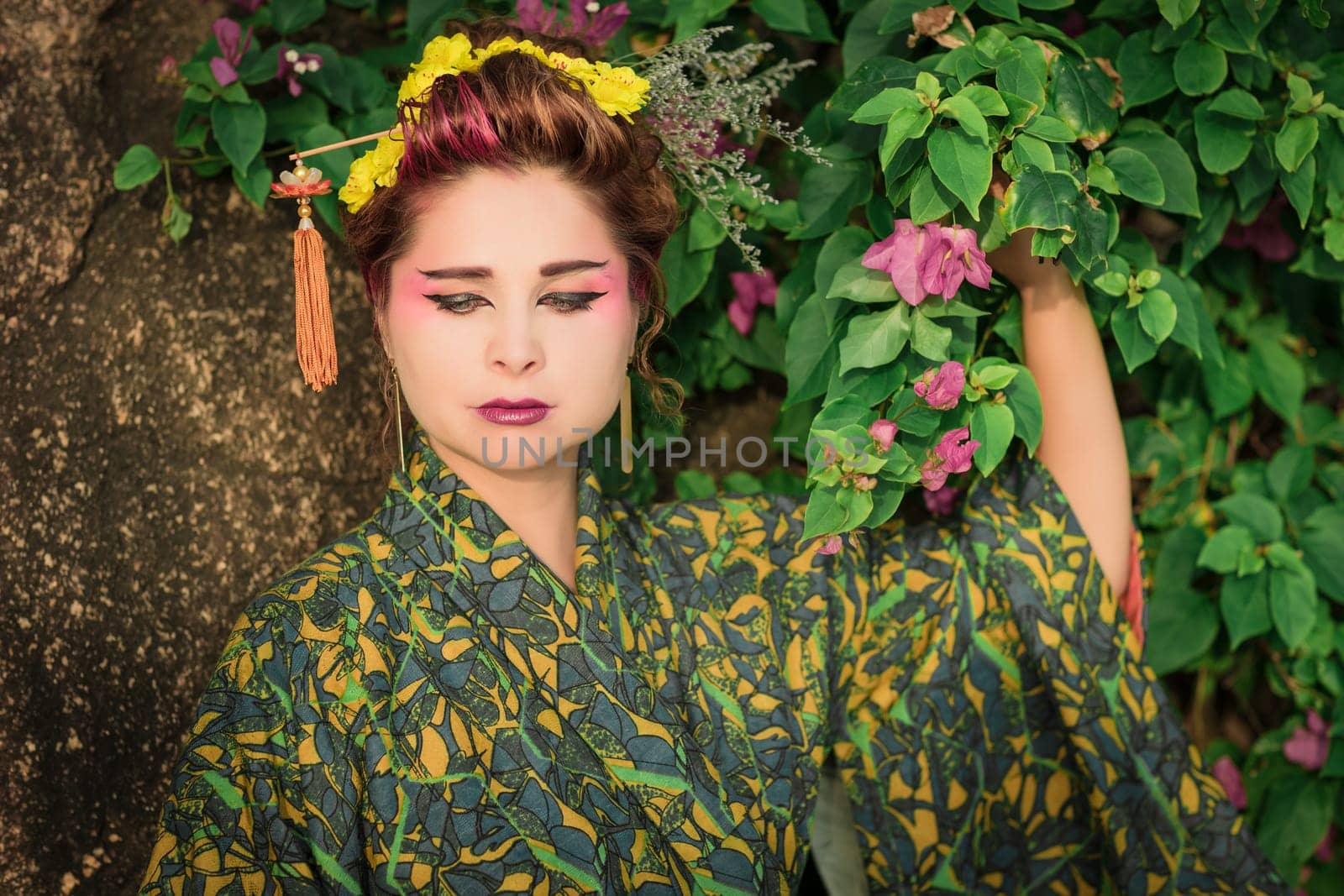 Fine art portrait of beautiful woman in Japanese Geisha style wearing kimono