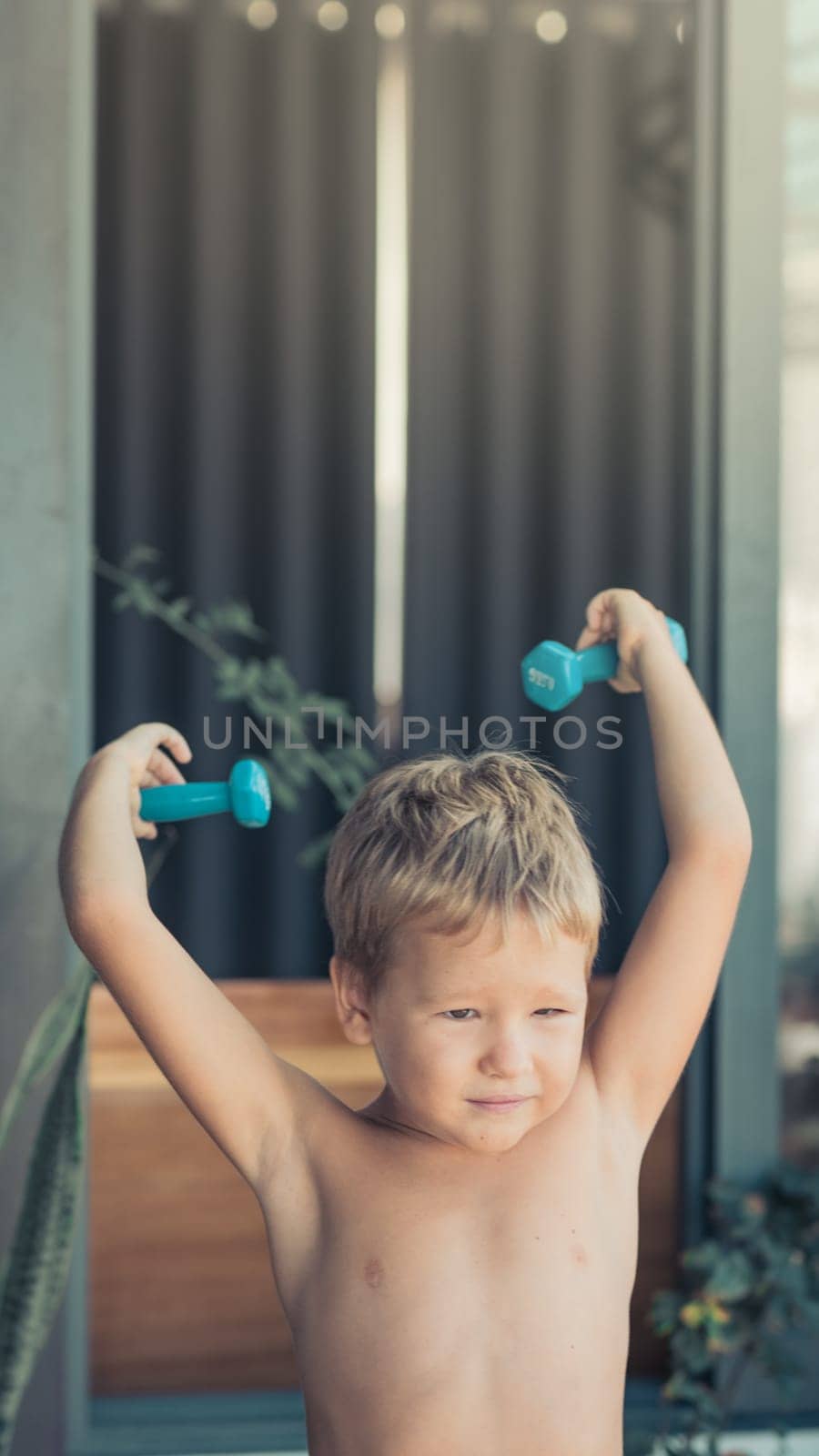 Portrait of a boy doing exercises. Self isolation at home