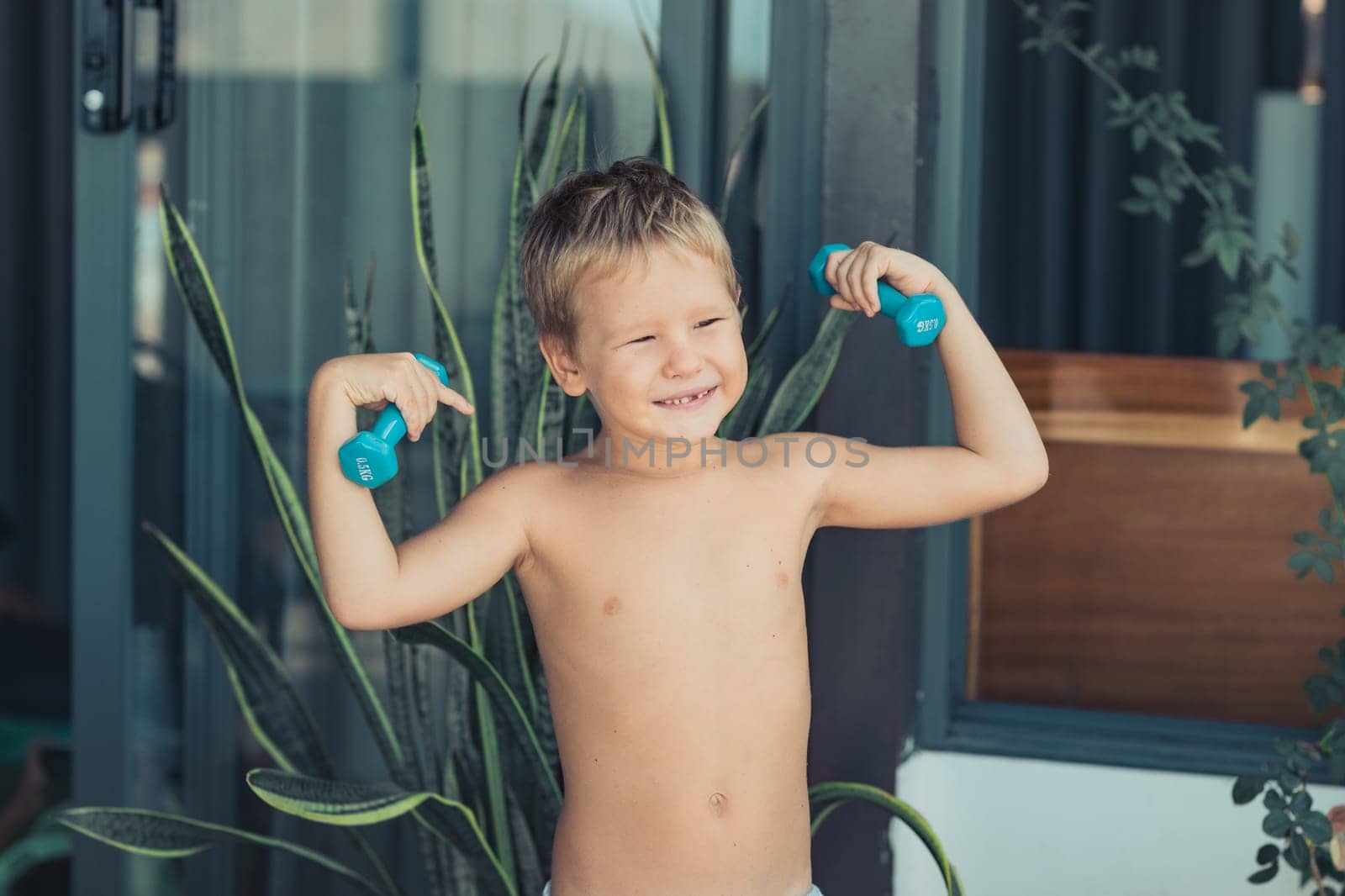 Portrait of a boy doing exercises. Self isolation at home