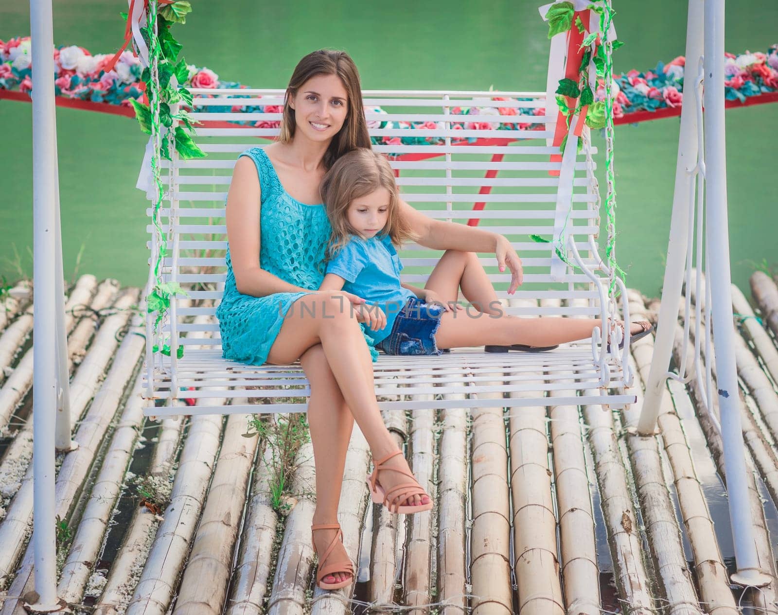 Outdoor portrait of a beautiful happy family. Mother and daughter together