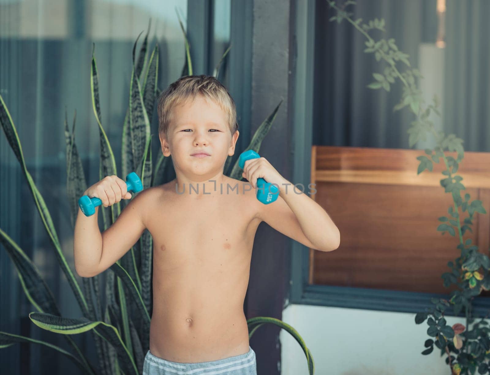 Portrait of a boy doing exercises. Self isolation at home