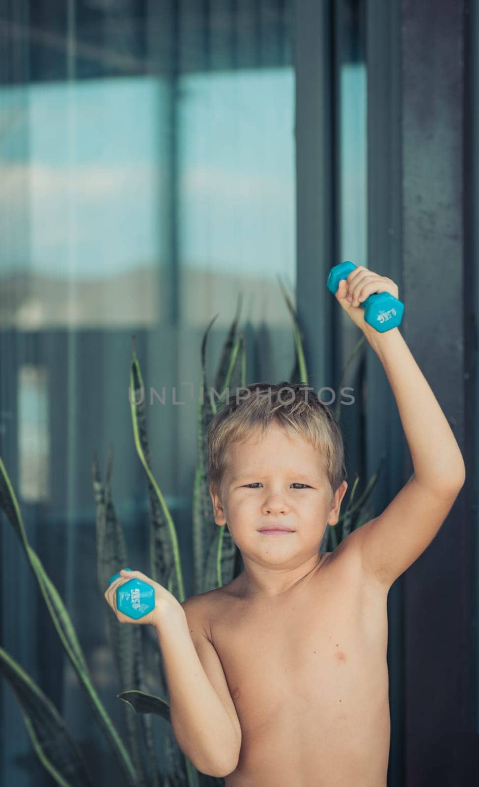 Portrait of a boy doing exercises. Self isolation at home